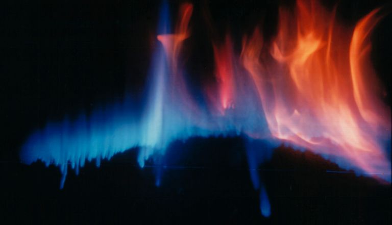Vibrant abstract flames in shades of blue and orange on a dark background.